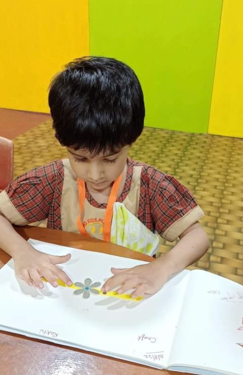 A boy working on an art activity at his desk