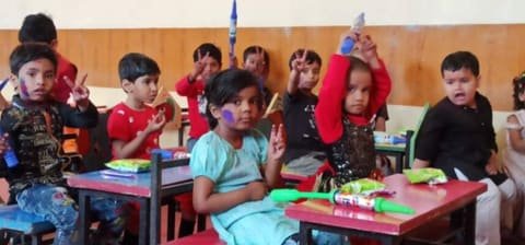 Children at their desks in a classroom