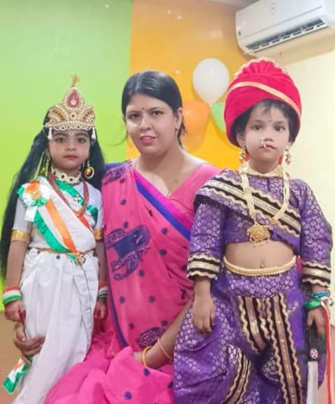 Two children in costume standing with their teacher
