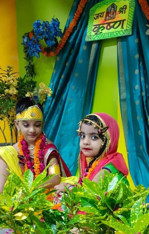 Two children dressed as Krishna and Radha at the Janmashtami celebration
