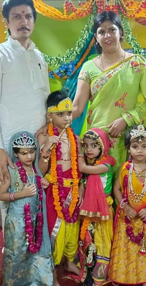 Children dressed as Krishna and Radha with two adults from the school