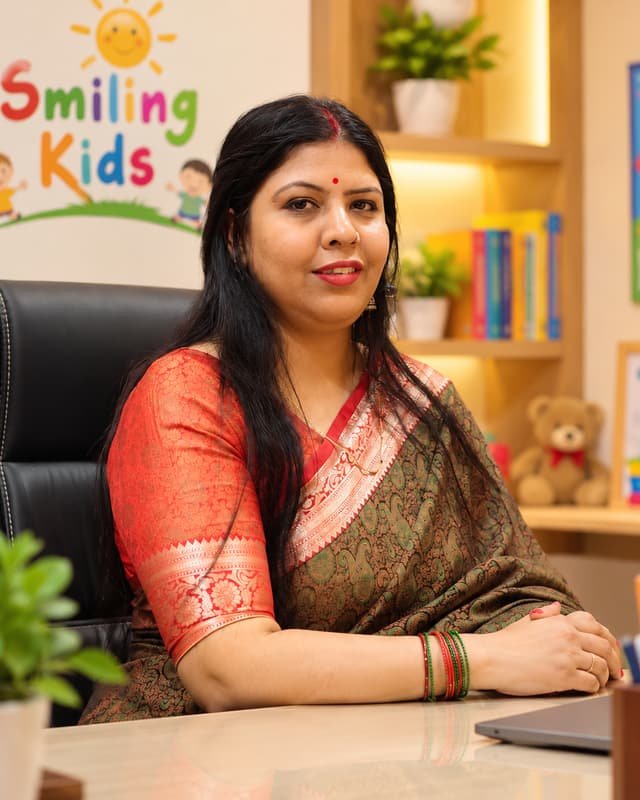 Principal of Smiling Kids Play School, at the desk in the school office